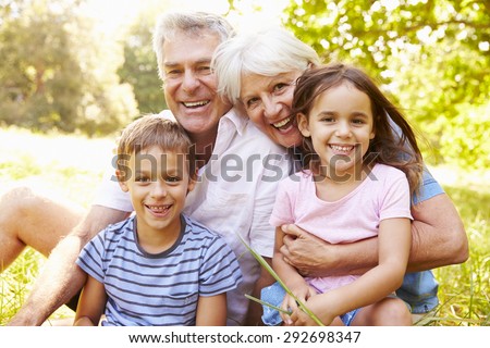 Grandparents sitting outdoors with their grandchildren