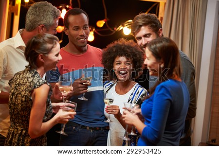 Group of adult friends drinking at a house party