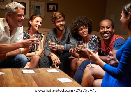 Group of friends sitting around a table at house party