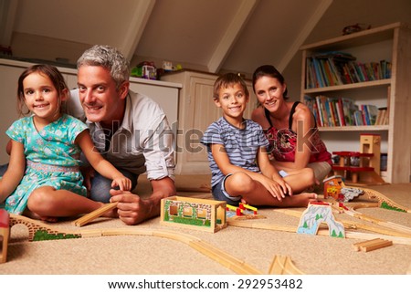 Family playing with toys in an attic playroom, portrait