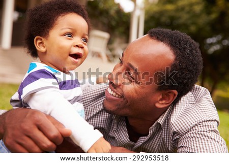 Father bonding with his toddler son in a garden