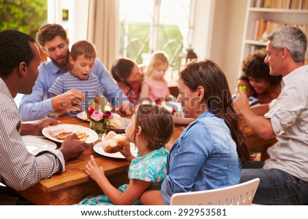 Family and friends sitting at a dining table