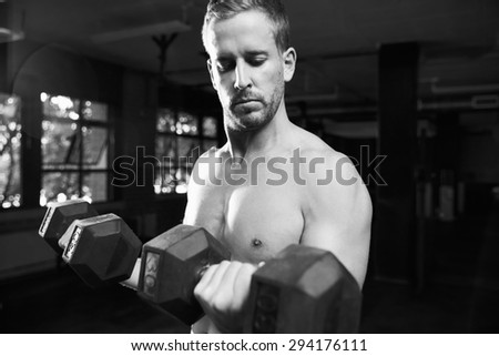 Black And White Shot Of Bare Chested Man Lifting Weights