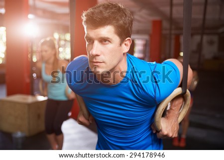 Man In Gym Exercising With Gymnastic Rings