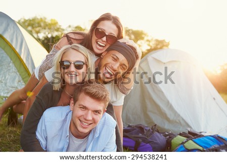 Group Of Friends Having Fun Outside Tents On Camping Holiday
