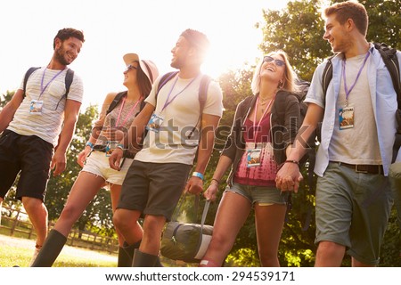 Group Of Young People Going Camping At Music Festival