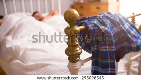 Young Couple Lying Asleep In Bedroom Together