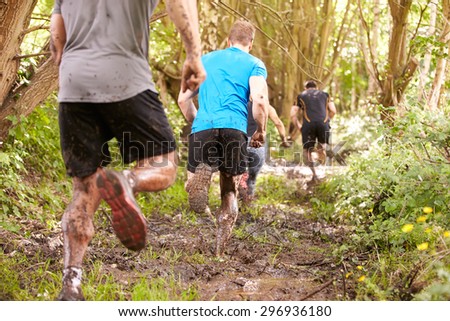 Competitors running in a forest at an endurance event