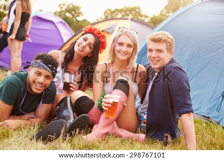 Group of friends hanging out at a music festival campsite