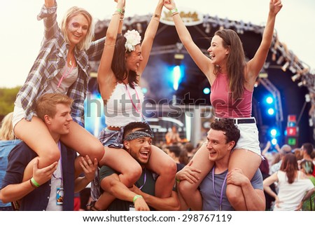 Friends having fun in the crowd at a music festival