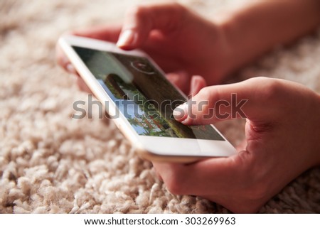 Close up of persons hands playing a game on a smartphone