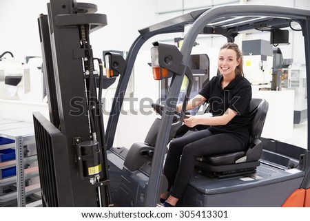 Portrait Of Female Fork Lift Truck Driver In Factory