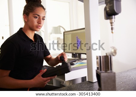 Female Engineer Using CAD System To Work On Component