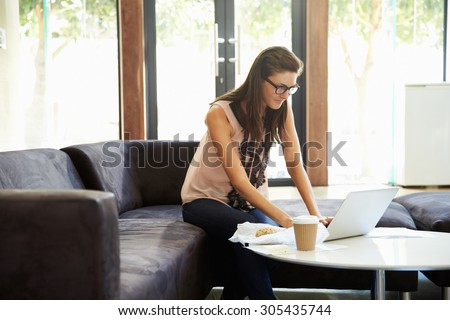 Businesswoman Having Working Lunch In Office