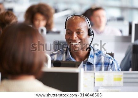African American man working at a computer in a call centre