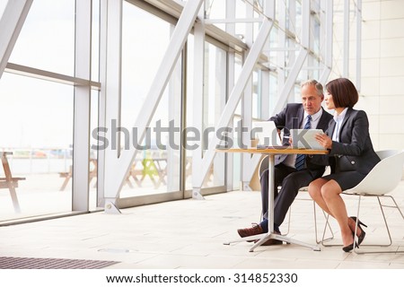 Two senior business colleagues at meeting in modern interior