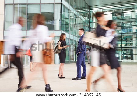 People passing through the busy foyer of a business building