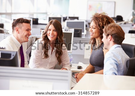 Four young office colleagues in a casual team meeting