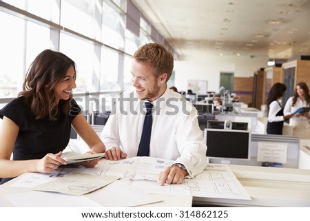 Young man and woman working together in architect?s office