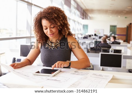 Young African American female architect working in an office