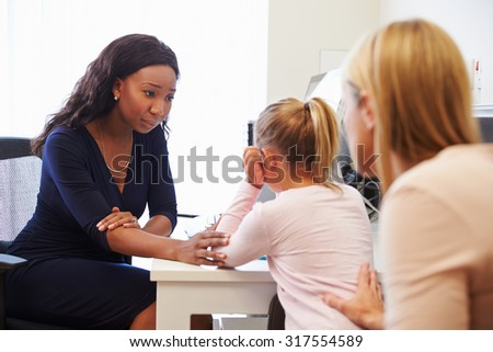 Mother And Daughter Visiting Doctor In Surgery