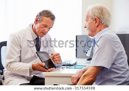 Senior Patient Having Consultation With Doctor In Office