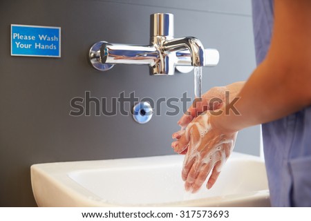Close Up Of Medical Staff Washing Hands