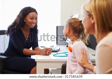 Mother And Daughter Visiting Doctor In Surgery