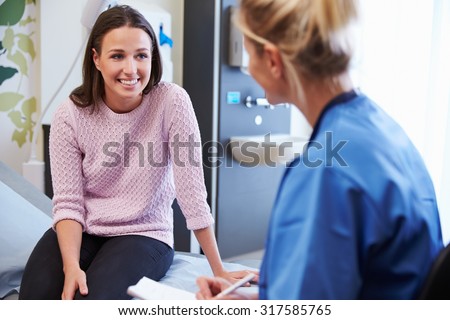 Female Patient And Nurse Have Consultation In Hospital Room