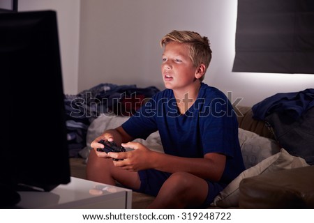 Teenage Boy Addicted To Video Gaming At Home
