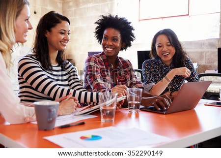 Group Of Female Designers Having Meeting In Modern Office