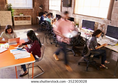 Elevated View Of Workers In Busy Modern Design Office