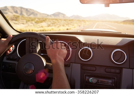 Close Up Of Driver\'s Hands On Car Steering Wheel