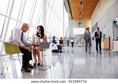 Business Meetings In Busy Office Foyer Area