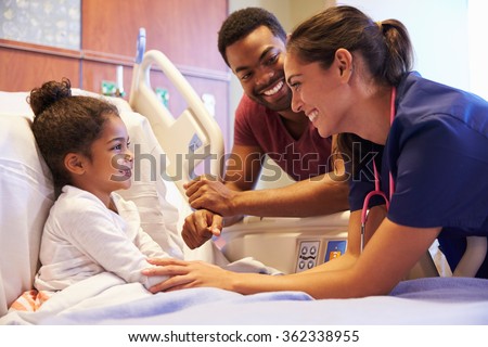 Pediatrician Visiting Father And Child In Hospital Bed