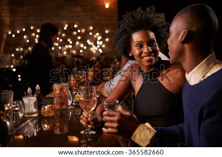 Couple Enjoying Night Out At Cocktail Bar