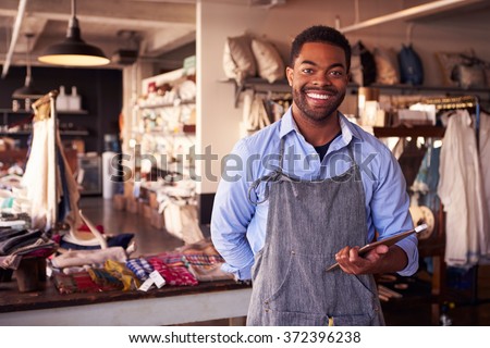 Portrait Of Male Owner Of Gift Store With Digital Tablet