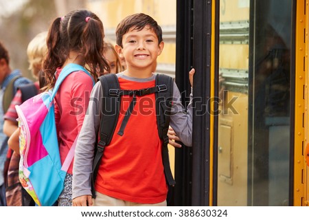 Elementary school boy at the front of the school bus queue