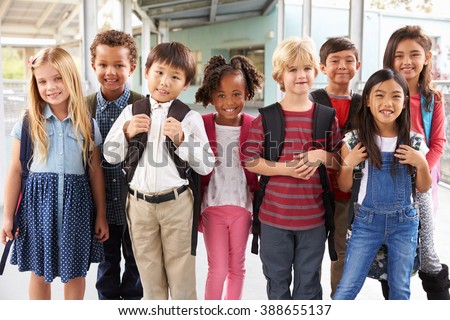 Group portrait of elementary school kids in school corridor