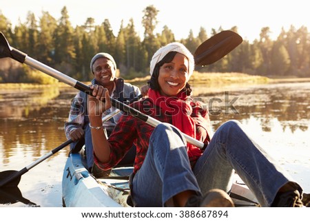 Senior African American Couple Rowing Kayak On Lake