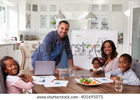 Domestic meeting in the kitchen, family looking to camera