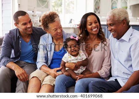 Grandparents and parents with a baby girl on mumÃ¢??s knee