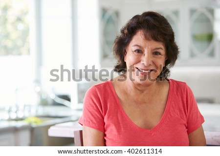 Head And Shoulders Portrait Of Senior Hispanic Woman At Home