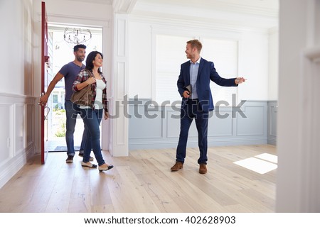 Realtor Showing Hispanic Couple Around New Home
