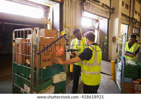 Warehouse manager overseeing the preparation of a delivery