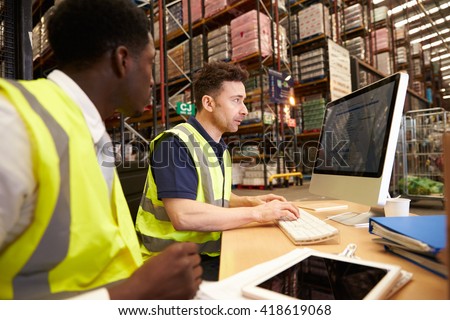 Staff working in on-site office at a distribution warehouse