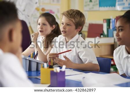 Primary school children work together in class, close up