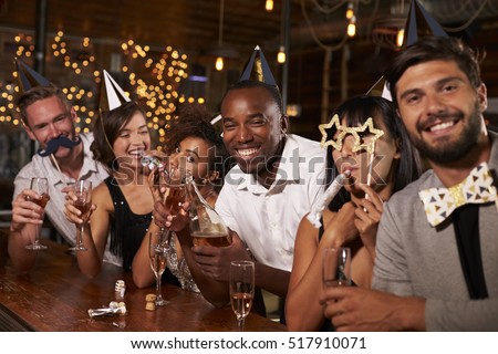 Friends celebrating New Year Eve at a party in a bar