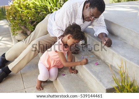 Grandfather And Granddaughter Drawing Picture On Steps