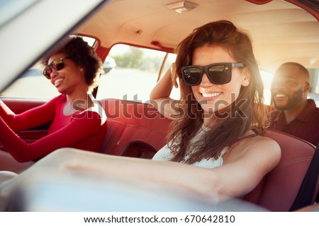 Group Of Friends Relaxing In Car During Road Trip
